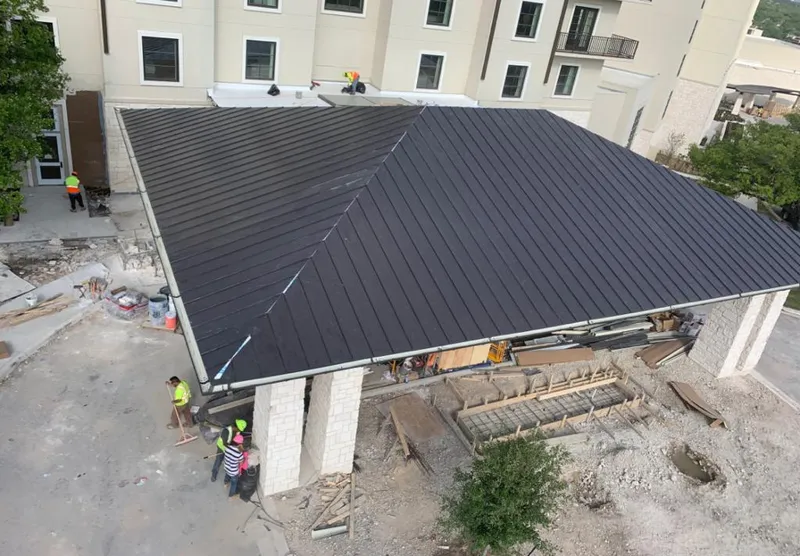 Metal roofing installation team working on a commercial building in Ansonia